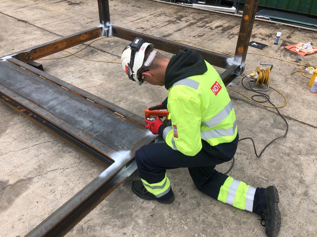 Magnetic Particle Inspection (MPI) being performed on a weld.