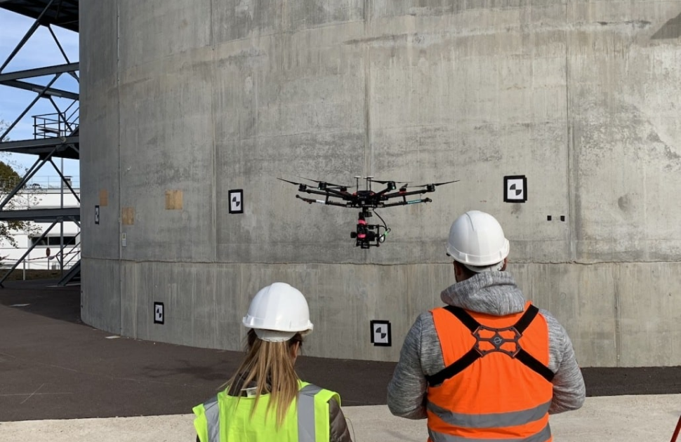 Two NDT Technician inspecting tank with help of a drone